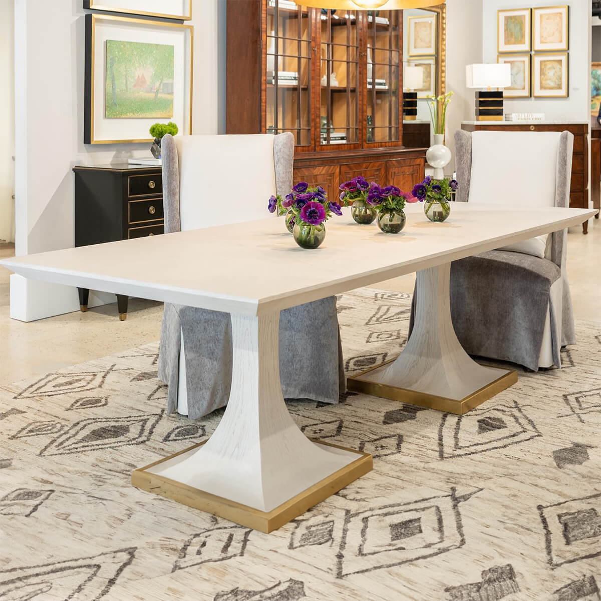 Art deco dining table styled with chairs and decor.