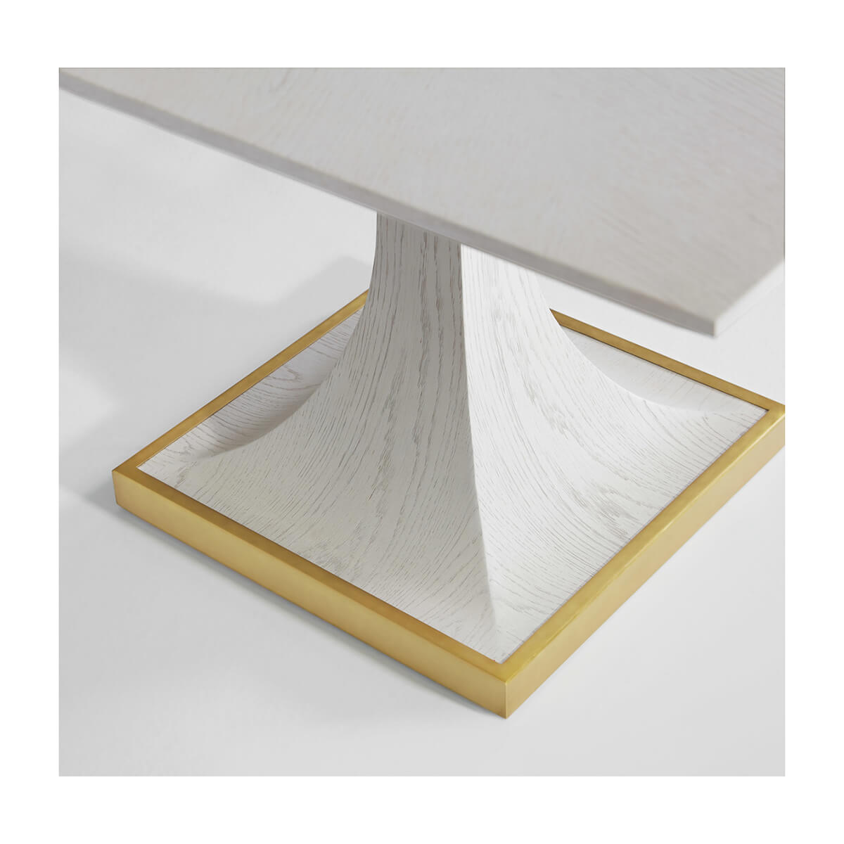 Close-up of art deco table base with gold trim.