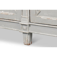 Close-up of leg and distressed finish of gray buffet.