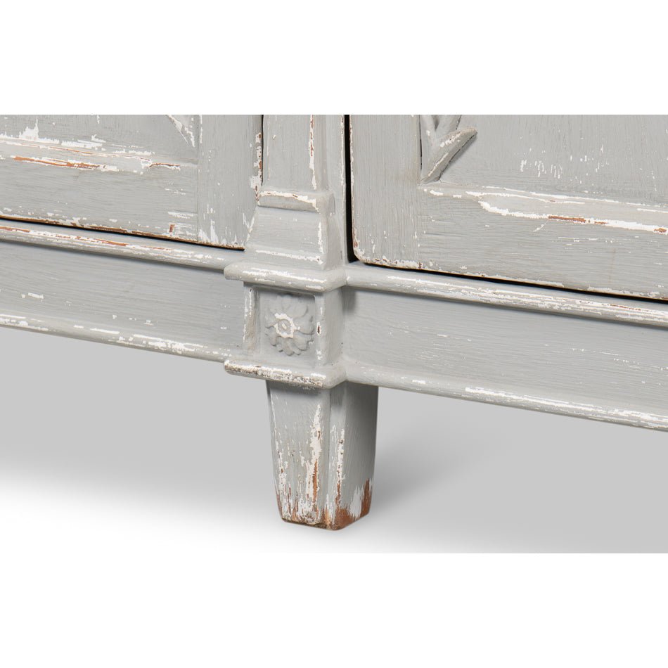Close-up of leg and distressed finish of gray buffet.