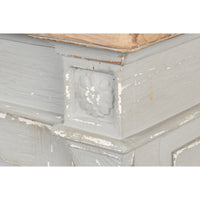 Decorative corner detail on gray Directoire style buffet.