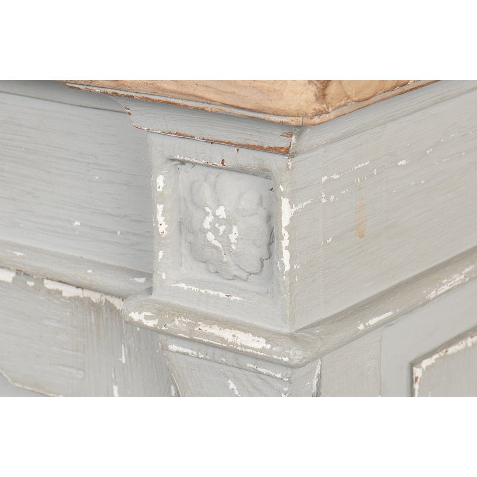 Decorative corner detail on gray Directoire style buffet.