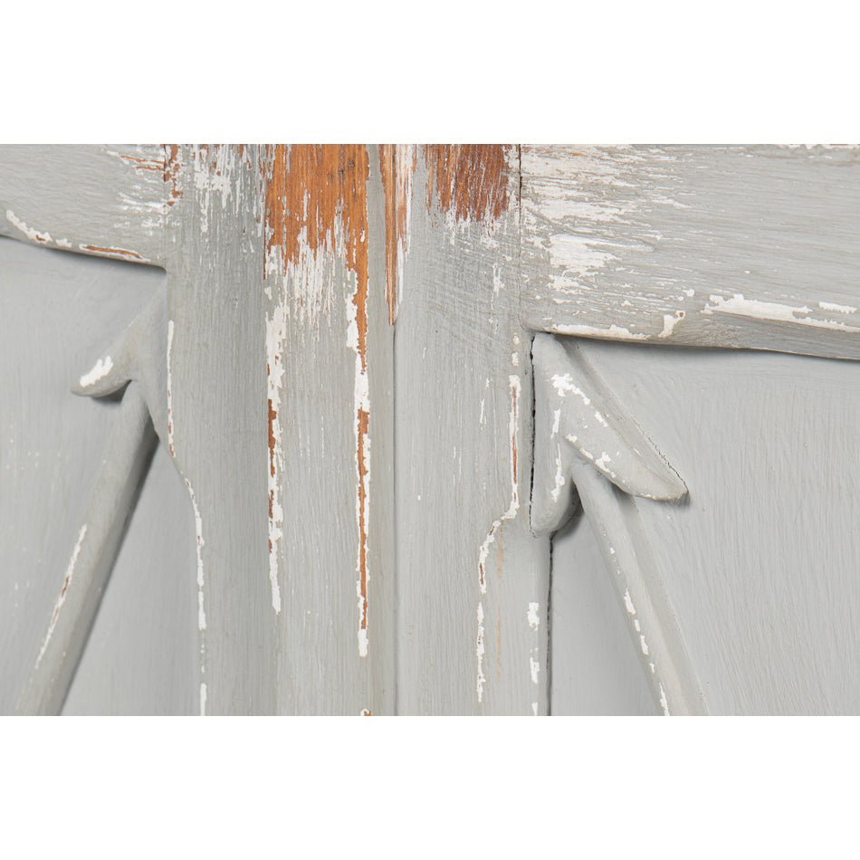Detailed view of distressed paint on antique buffet.