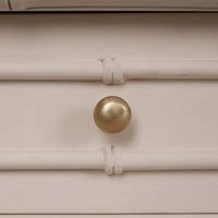 Brass knob detail on faux bamboo console table.