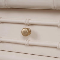 Close-up of drawer knob and design on console table.