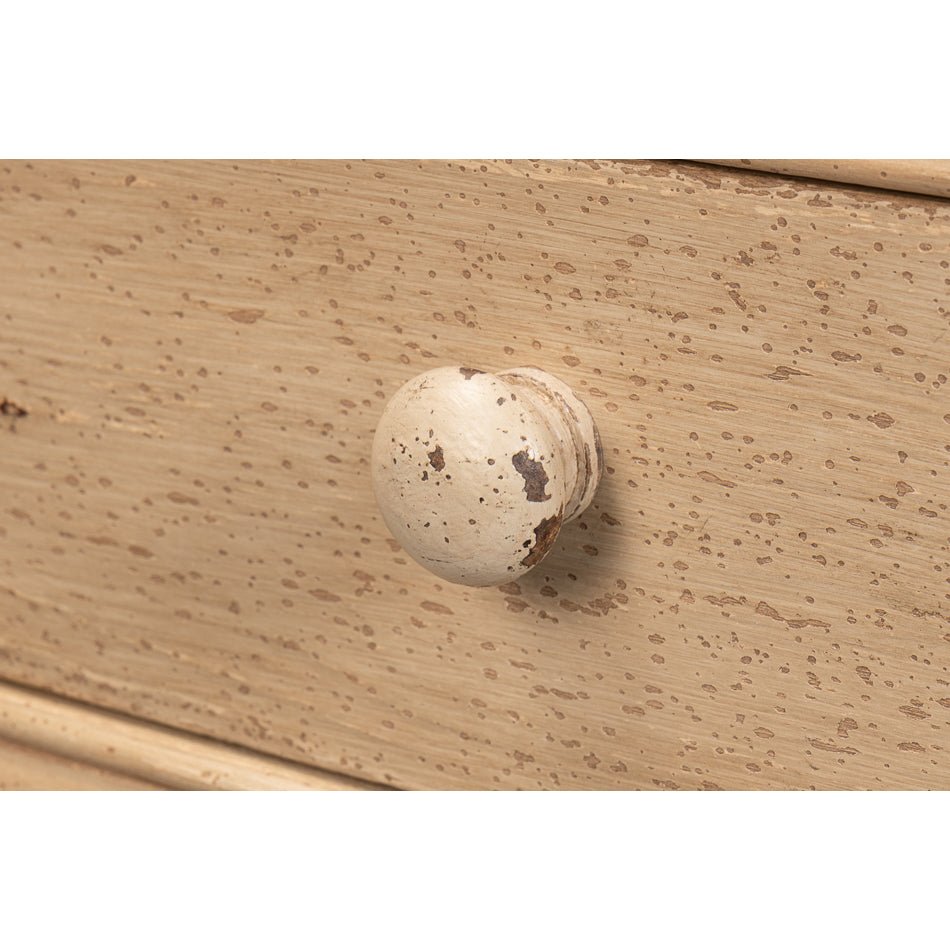 Close-up of drawer knob on console table.