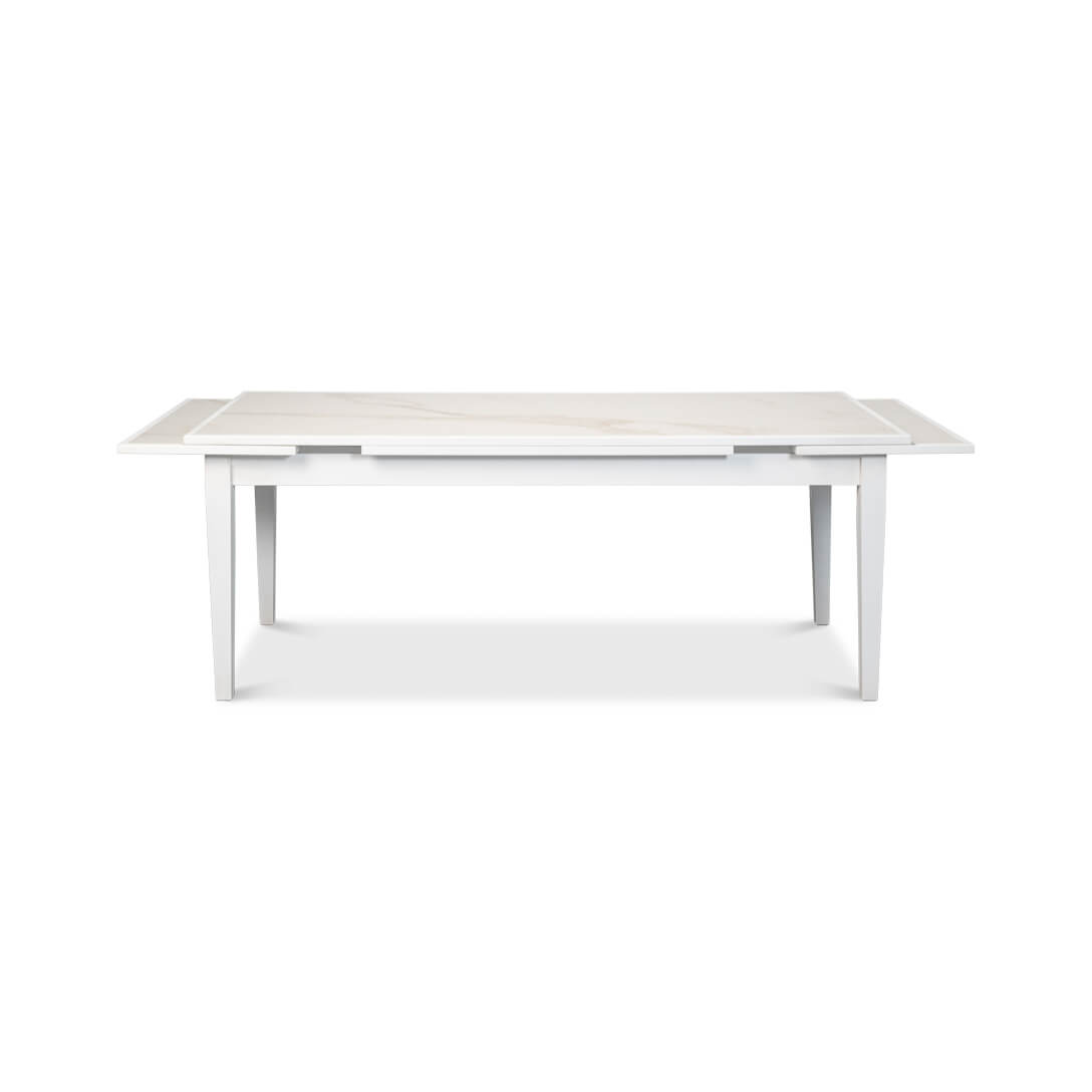 Partially extended white Italian dining table, front view.
