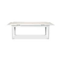 Partially extended white Italian dining table, front view.