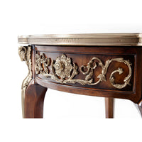 Close-up of floral carvings on mahogany lamp table.