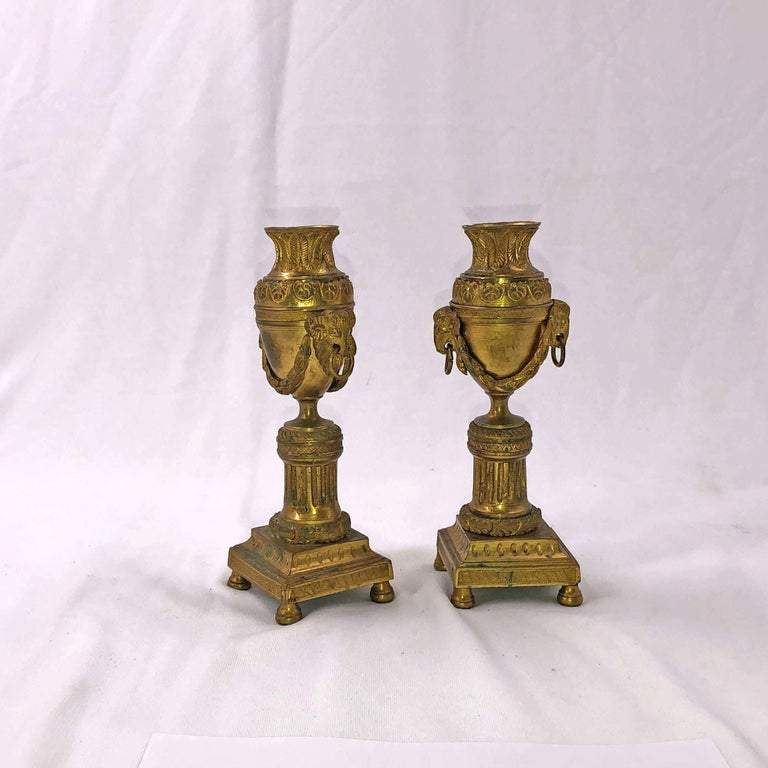 Bronze Louis XVI-style candelabra on white background close-up.