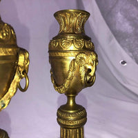 Close-up of ram's head detail on bronze cassolettes.