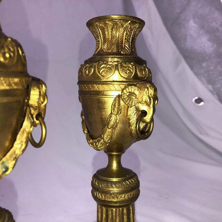 Close-up of ram's head detail on bronze cassolettes.