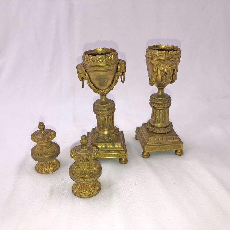Disassembled view of bronze Louis XVI-style candelabra components.