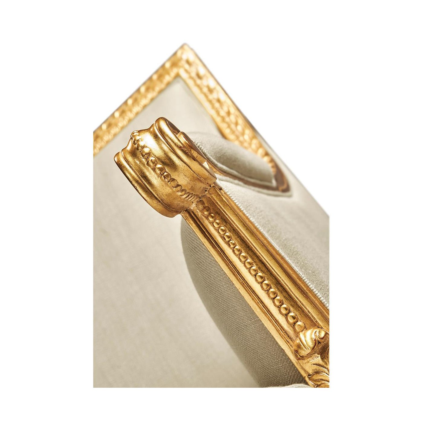 Louis XVI settee, close-up, armrest detailing with giltwood.