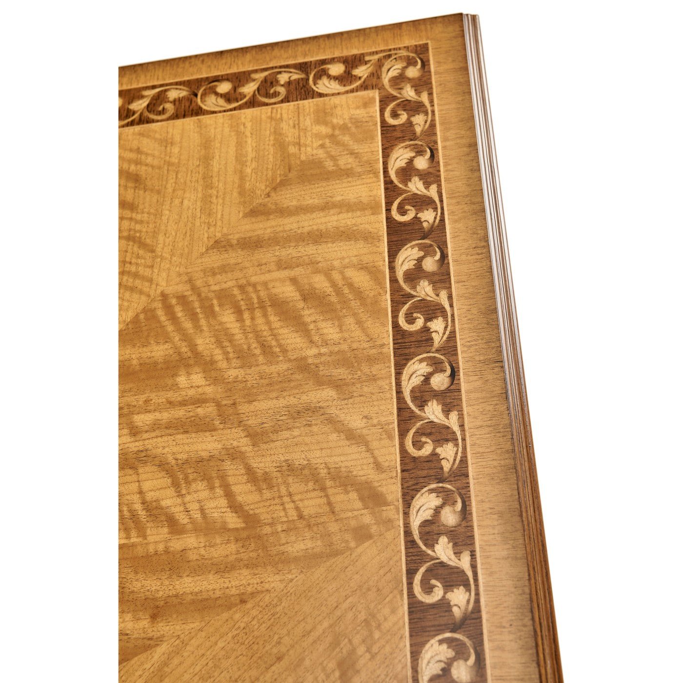 Close-up of coffee table border with decorative scrollwork.