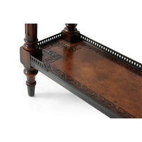 Close-up of lower shelf with intricate leather design.