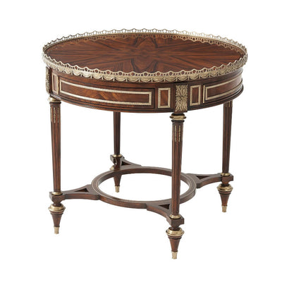 Louis XVI mahogany center table with ornate design.