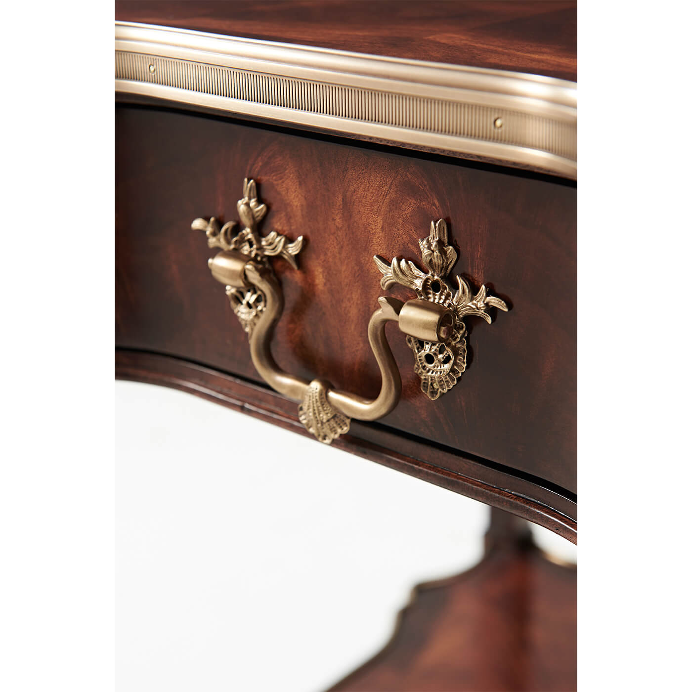 Close-up of drawer handle on mahogany end table.