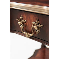 Close-up of drawer handle on mahogany end table.