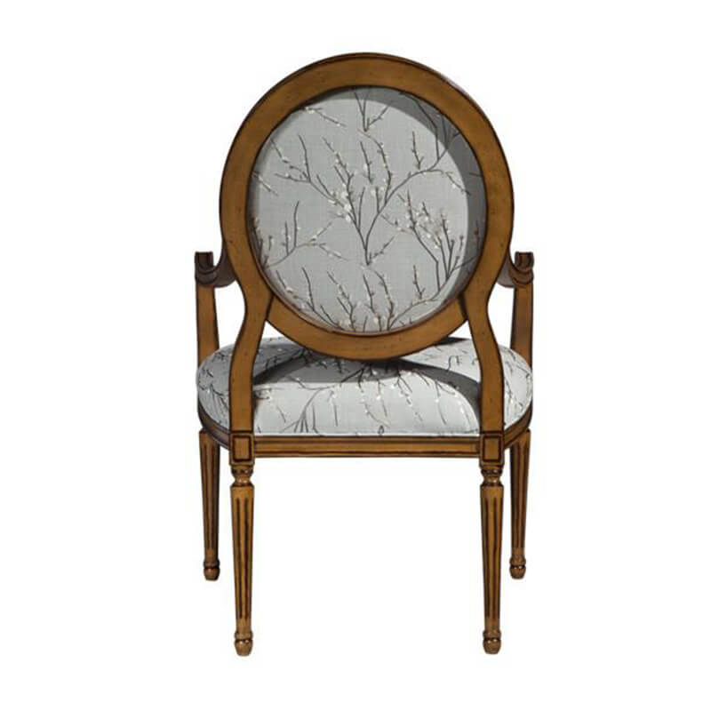 Louis XVI armchair back view, floral upholstery feature.