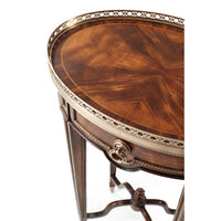 Oval end table, close-up, brass trim and detail.