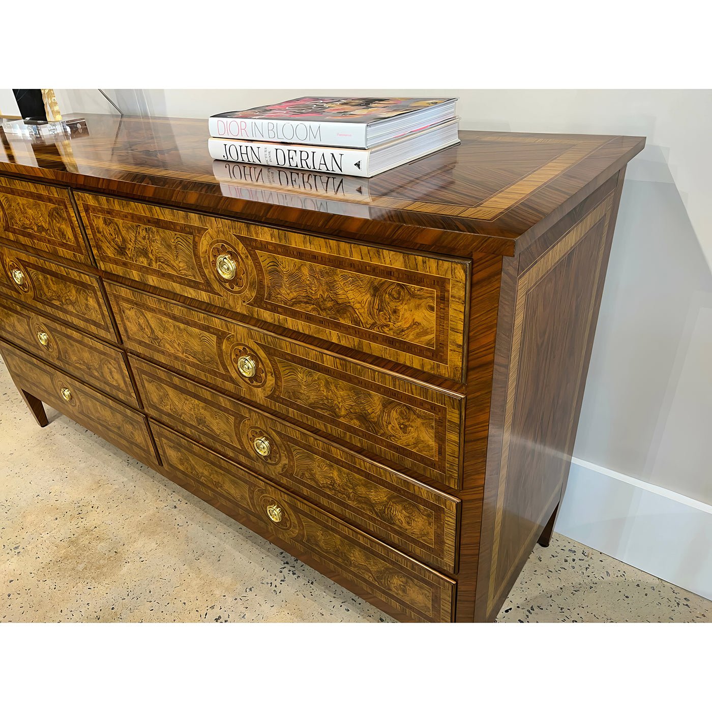 Louis XVI dresser with decorative books on top.