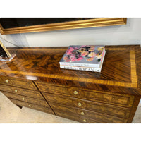 Top view of burl dresser with colorful books.