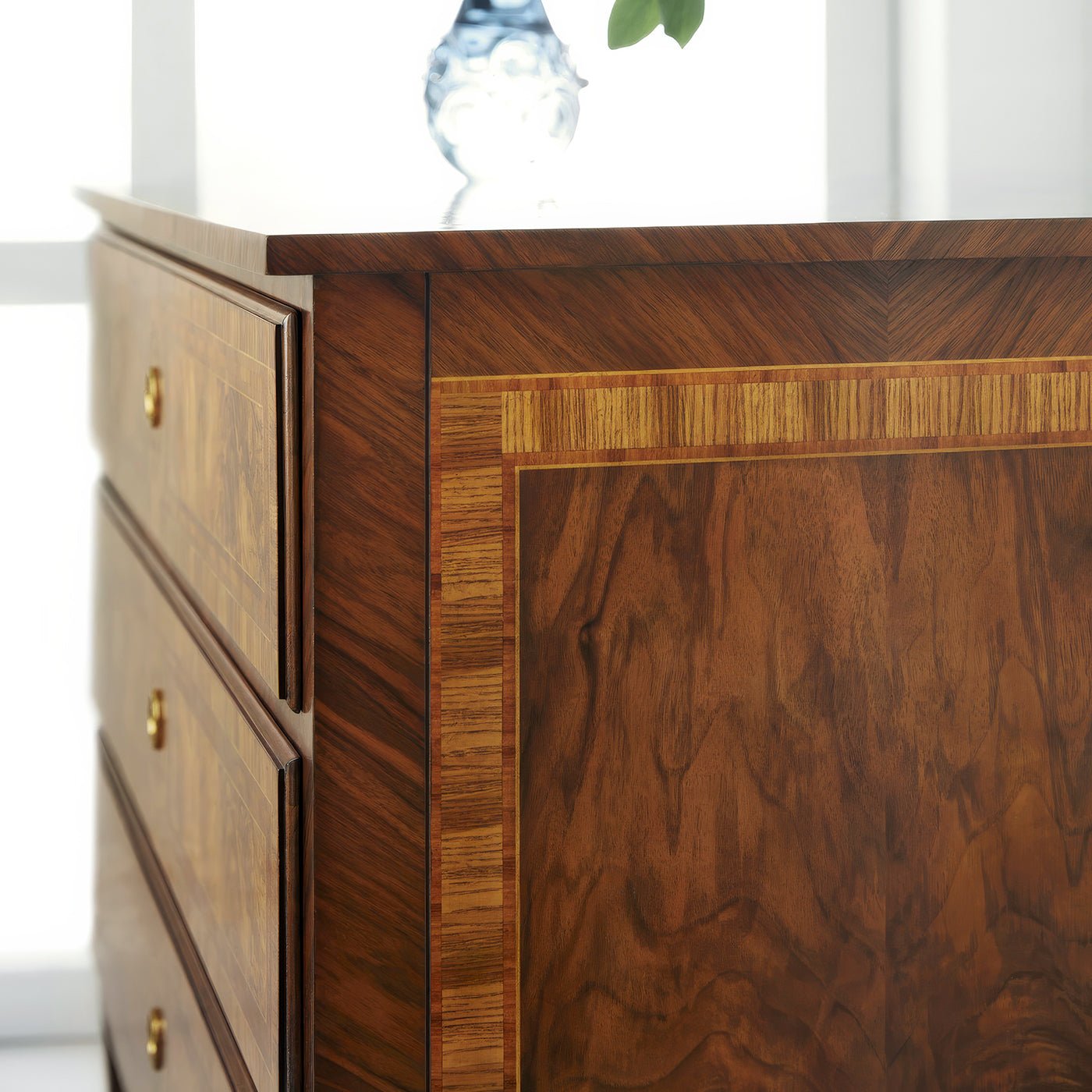 Side detail of Louis XVI burl nightstand, close-up.