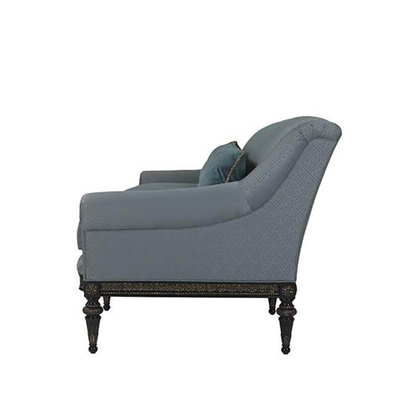 Dark blue sofa, side view, decorative legs.