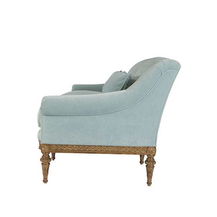 Light blue sofa, side view, decorative legs.