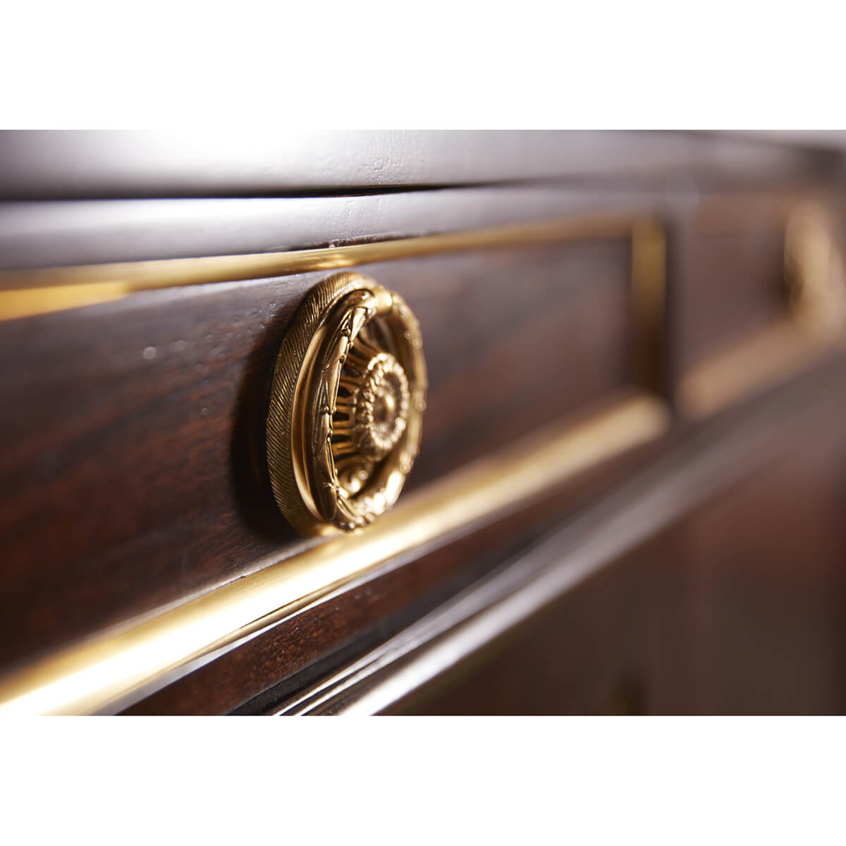 Detailed view of gold embellishments on Louis XVI buffet.