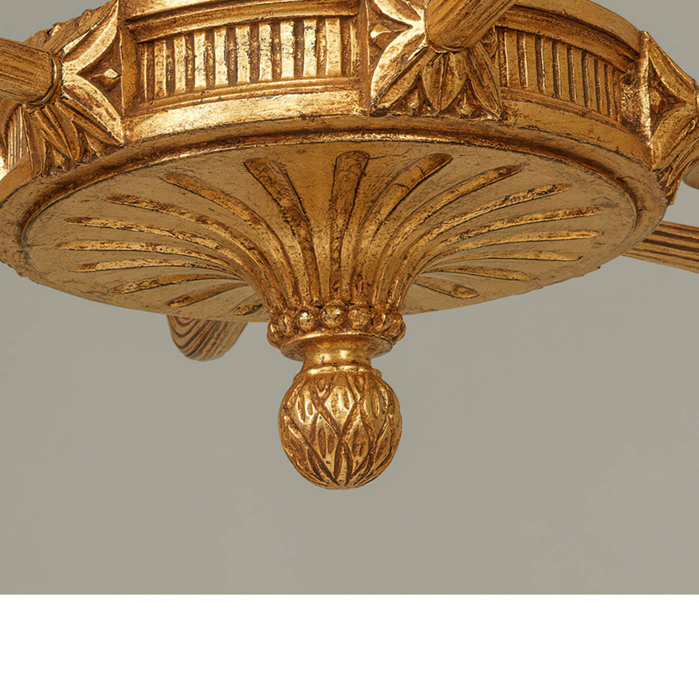 Bottom detail of elegant giltwood chandelier base design.
