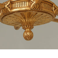 Bottom detail of elegant giltwood chandelier base design.