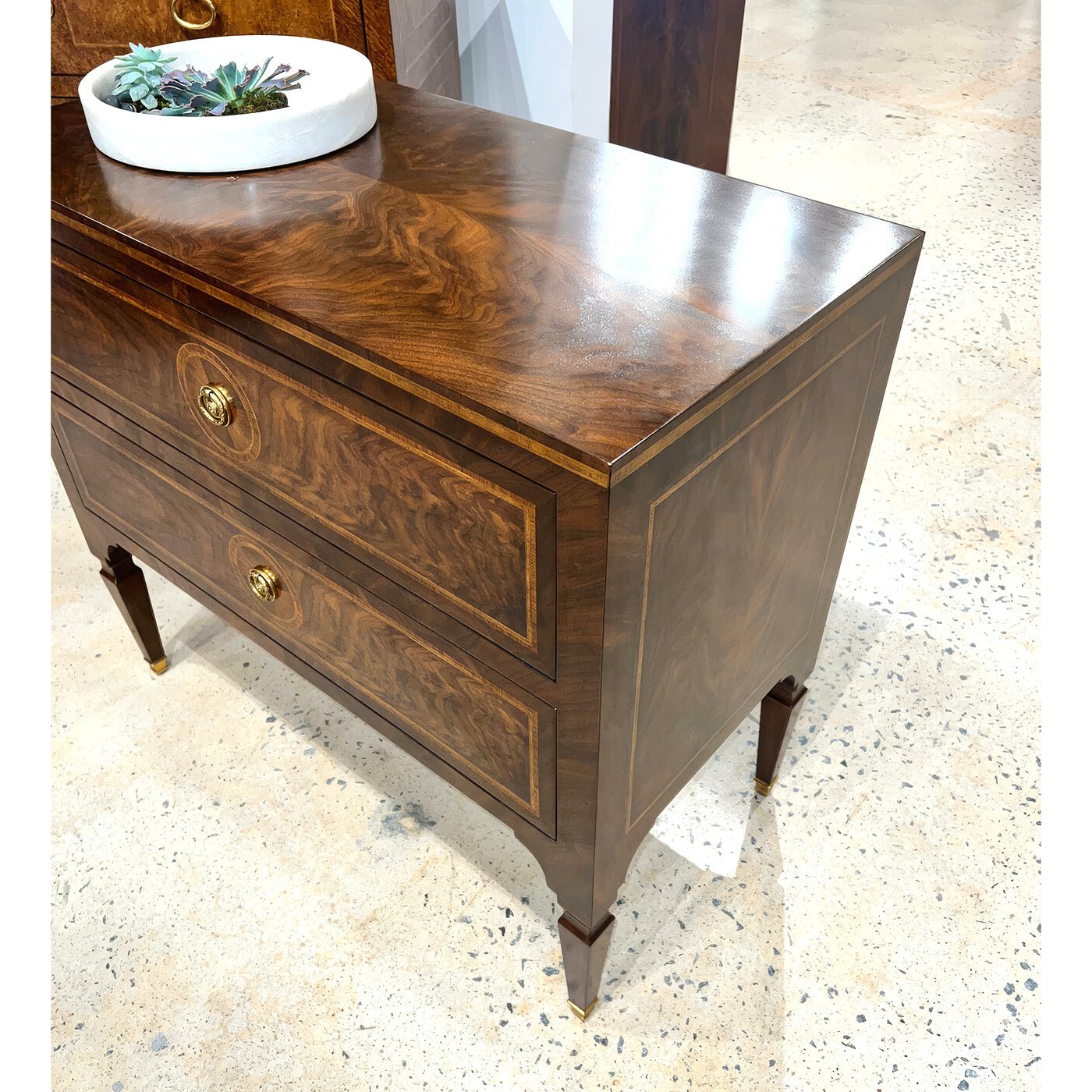 Top and side view of glossy wooden bedside chest.