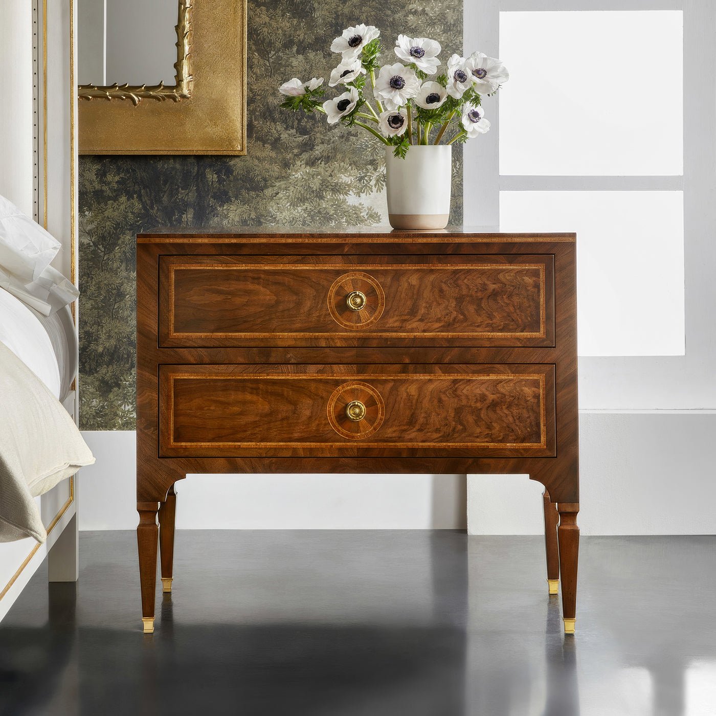 Elegant wooden bedside chest in stylish bedroom setting.