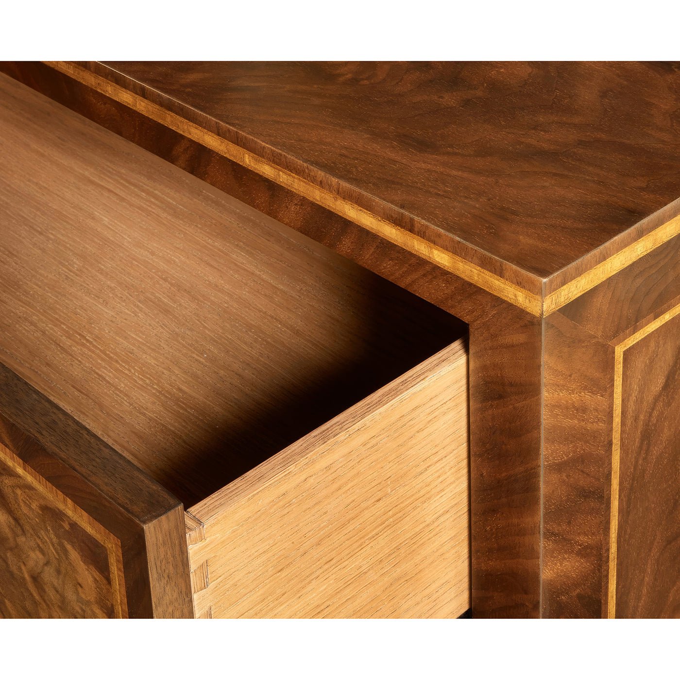 Open drawer of inlaid wooden bedside chest detail.