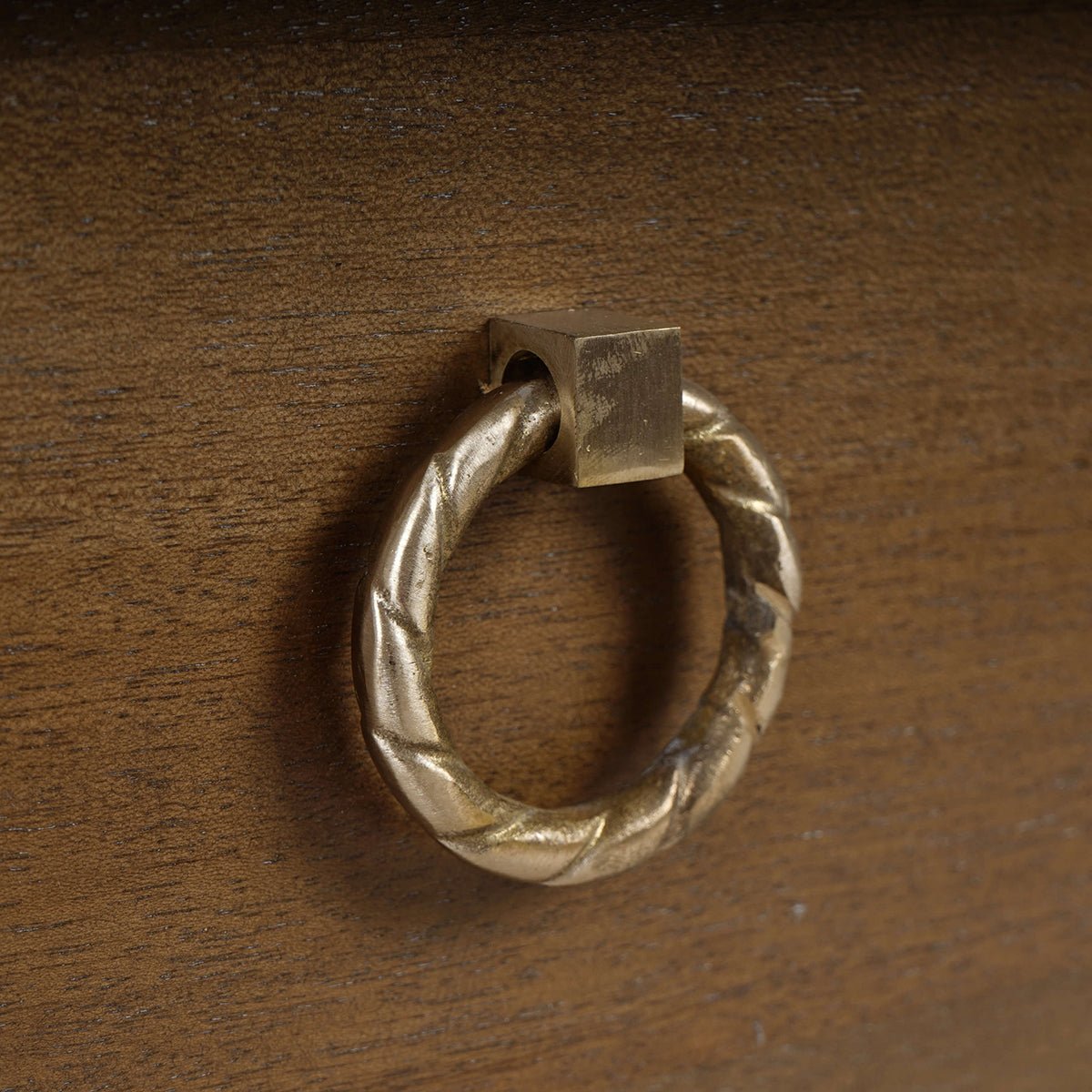 Close-up of drawer pull on mahogany antique dresser.