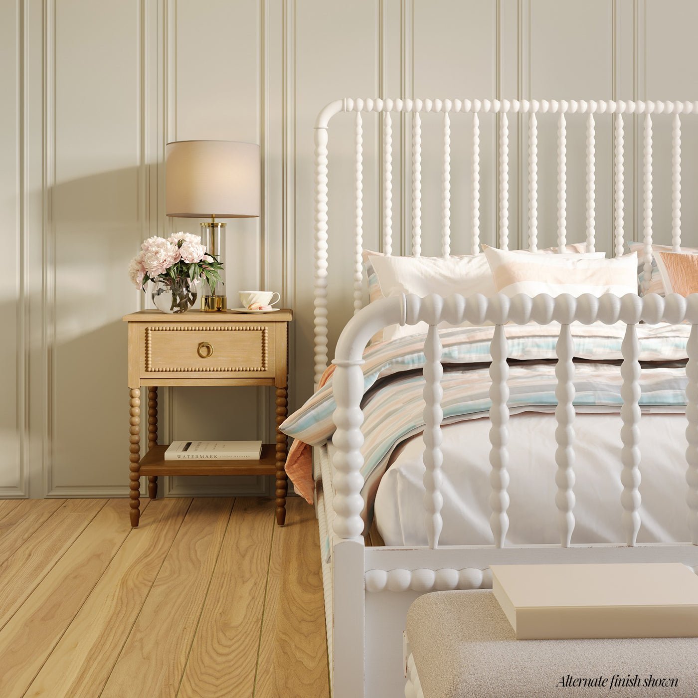 Nightstand beside bed in elegantly styled bedroom.