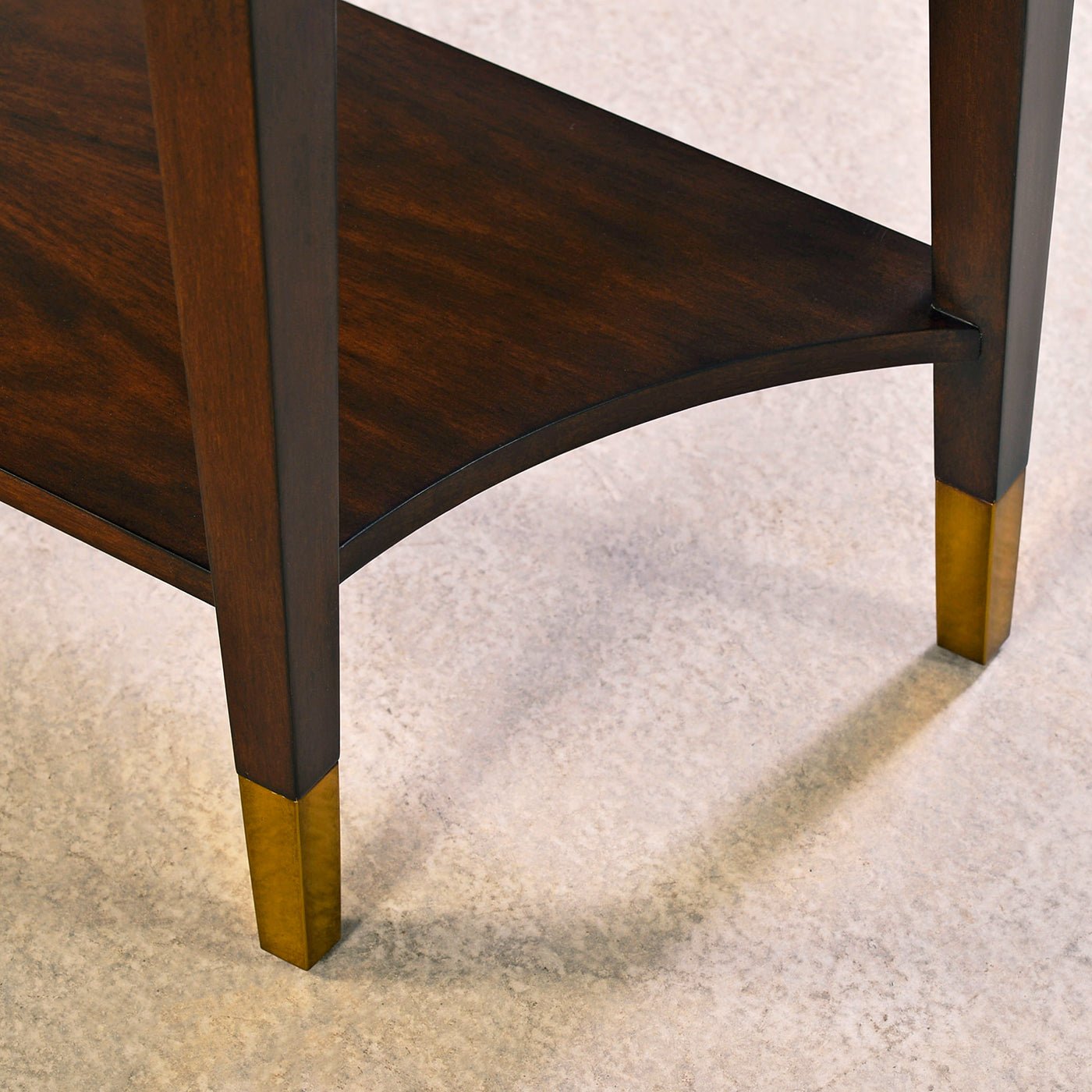 Shelf and leg detail of mahogany console table.