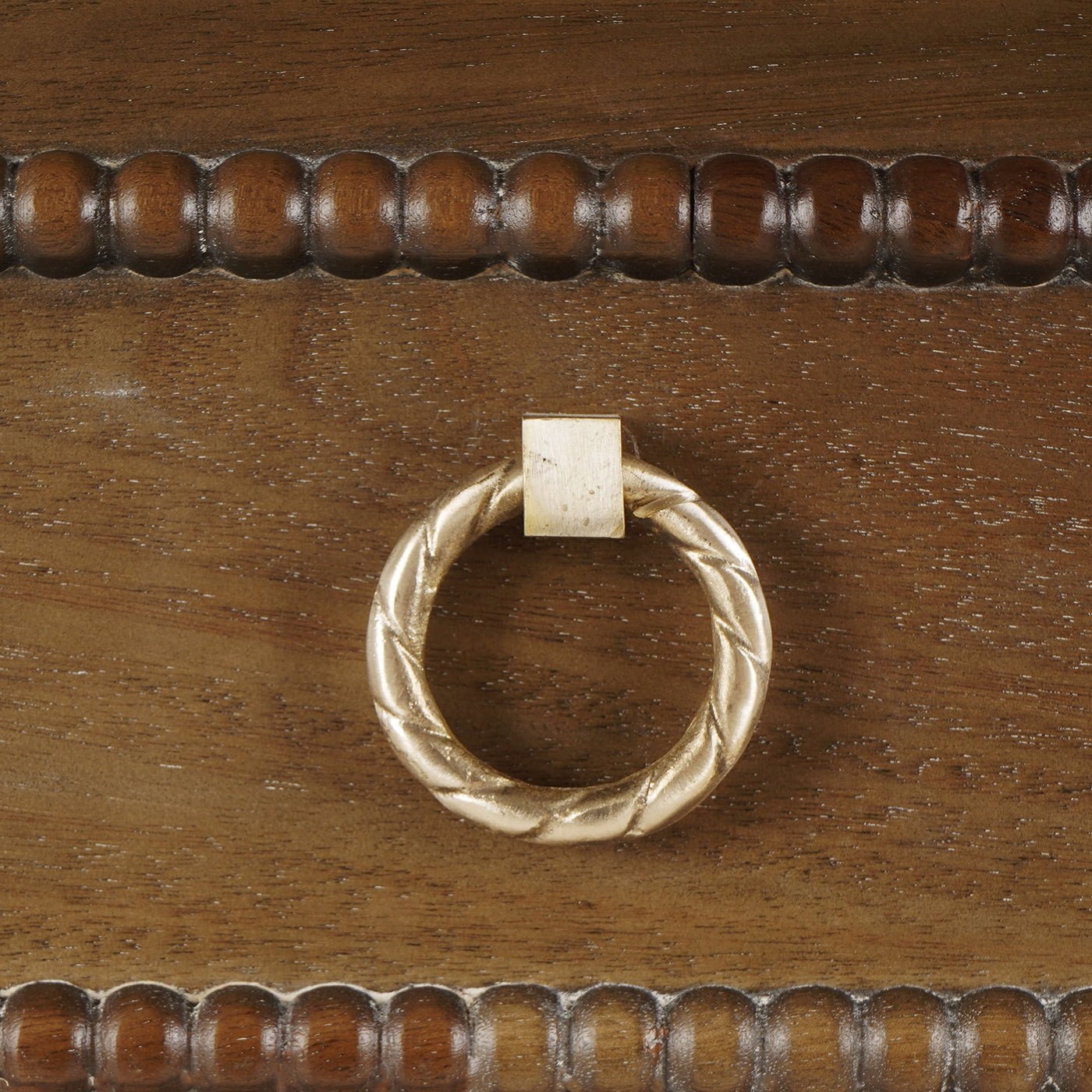 Close-up of mahogany chest drawer handle.