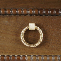 Close-up of mahogany chest drawer handle.
