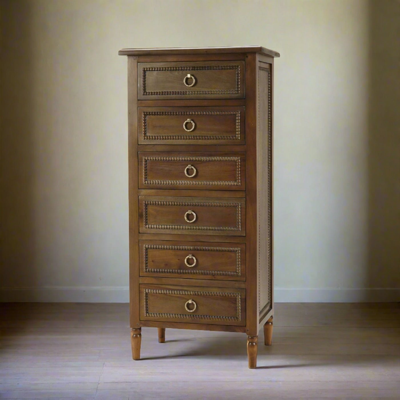 Mahogany lingerie chest in softly lit room.
