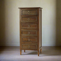 Mahogany lingerie chest in softly lit room.