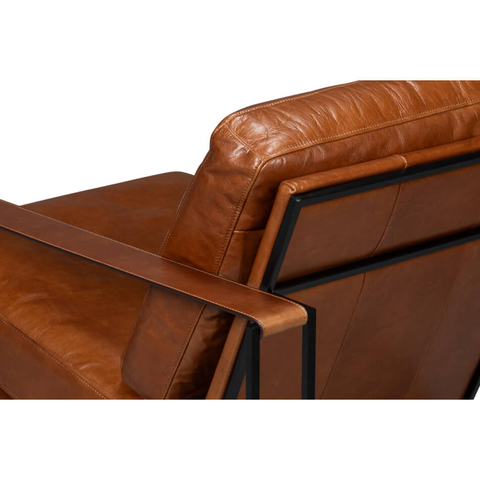 Angled back view showing leather cushion and armrest.