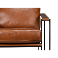 Close-up of seat and armrest on leather armchair.
