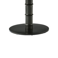 Dark metal base of round marble dining table