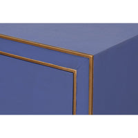 Corner detail of blue nightstand with gold trim.