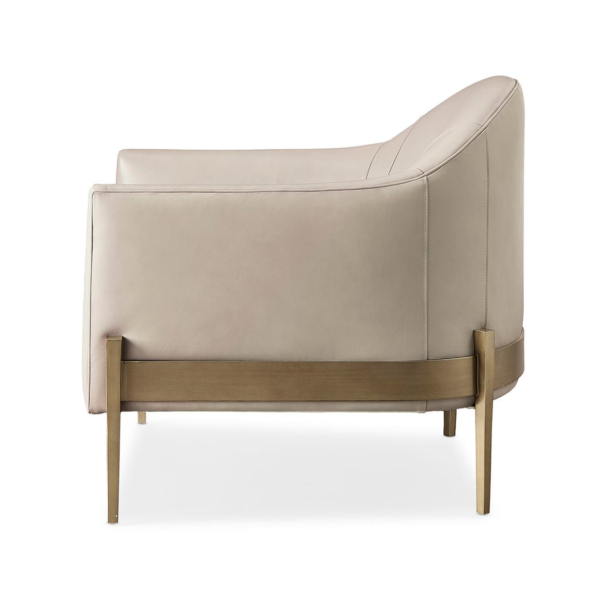 Side profile of beige mid-century barrel back armchair.