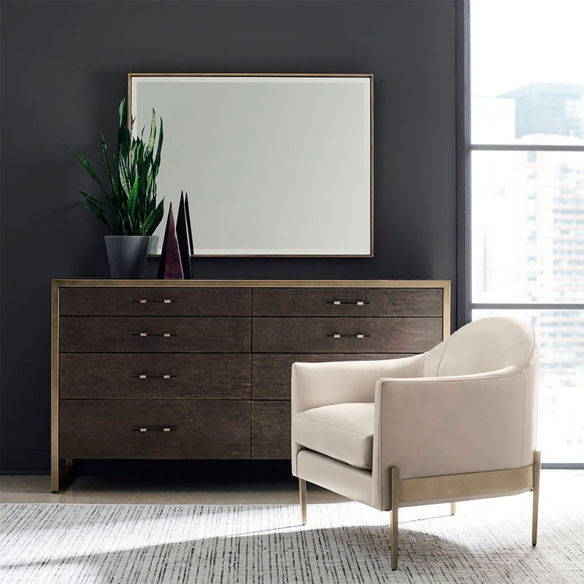 Mid-century armchair in room with dresser and mirror.