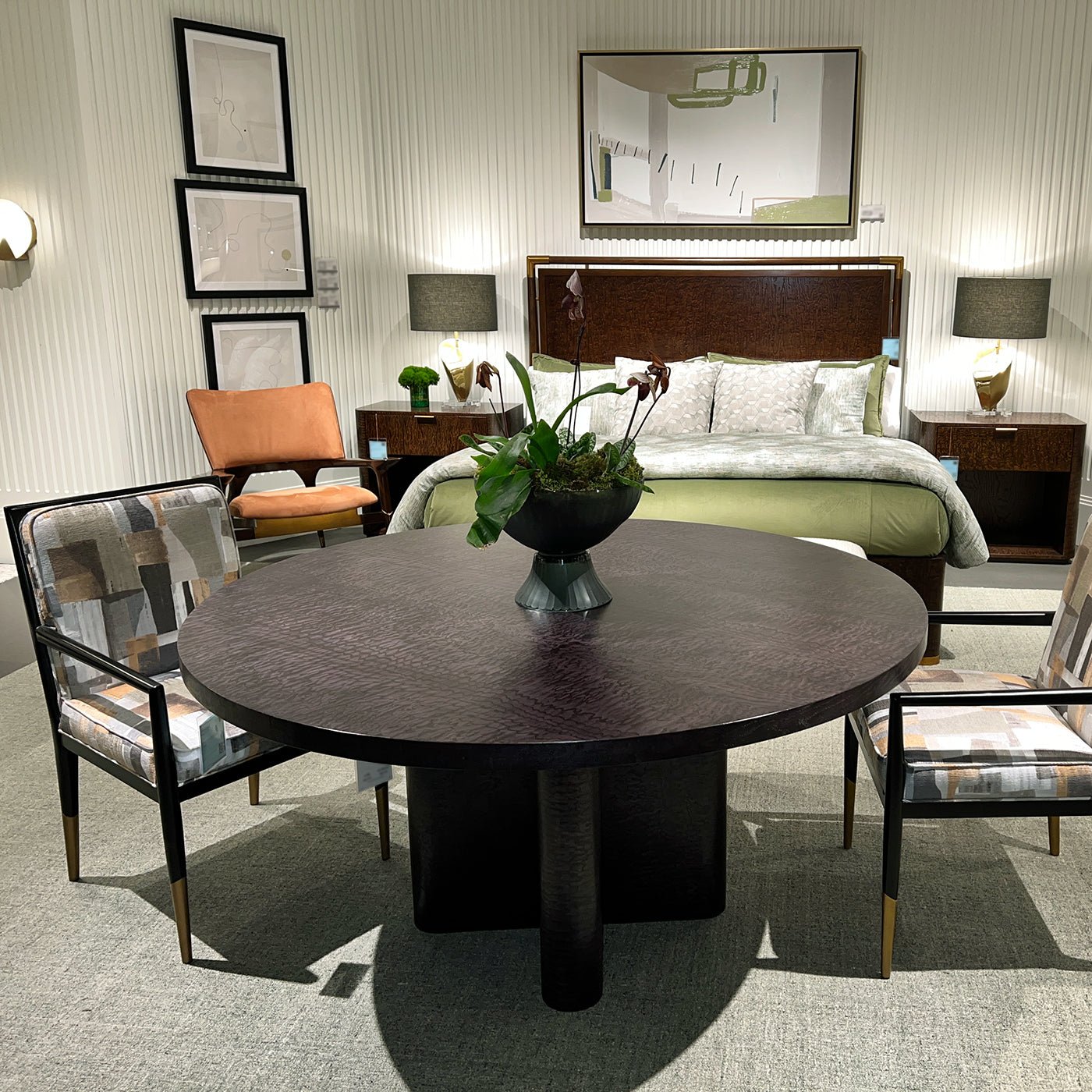 Dining table in bedroom setting with chairs and decor.